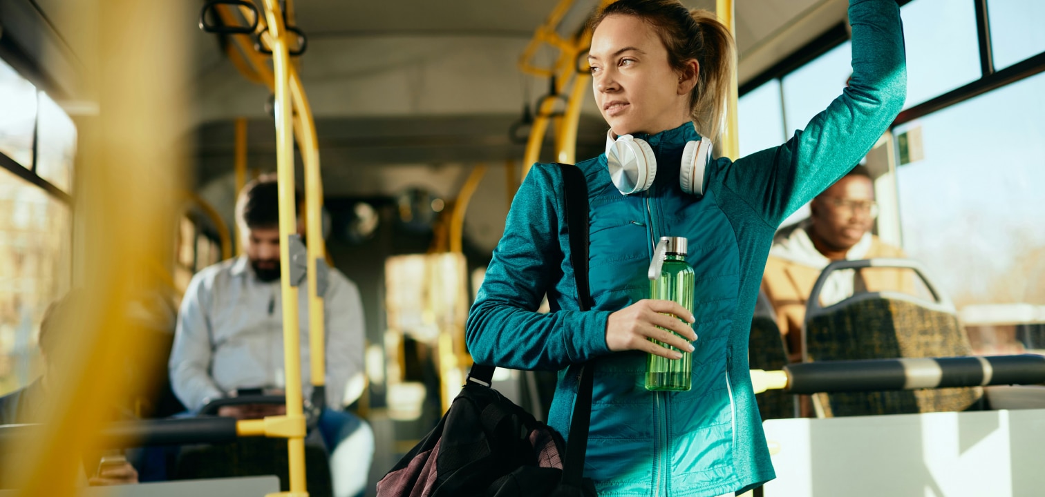 a woman holding a water bottle on a bus