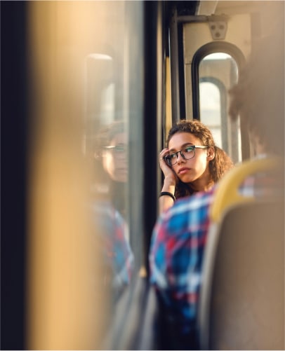 a woman leaning on her hand on a bus
