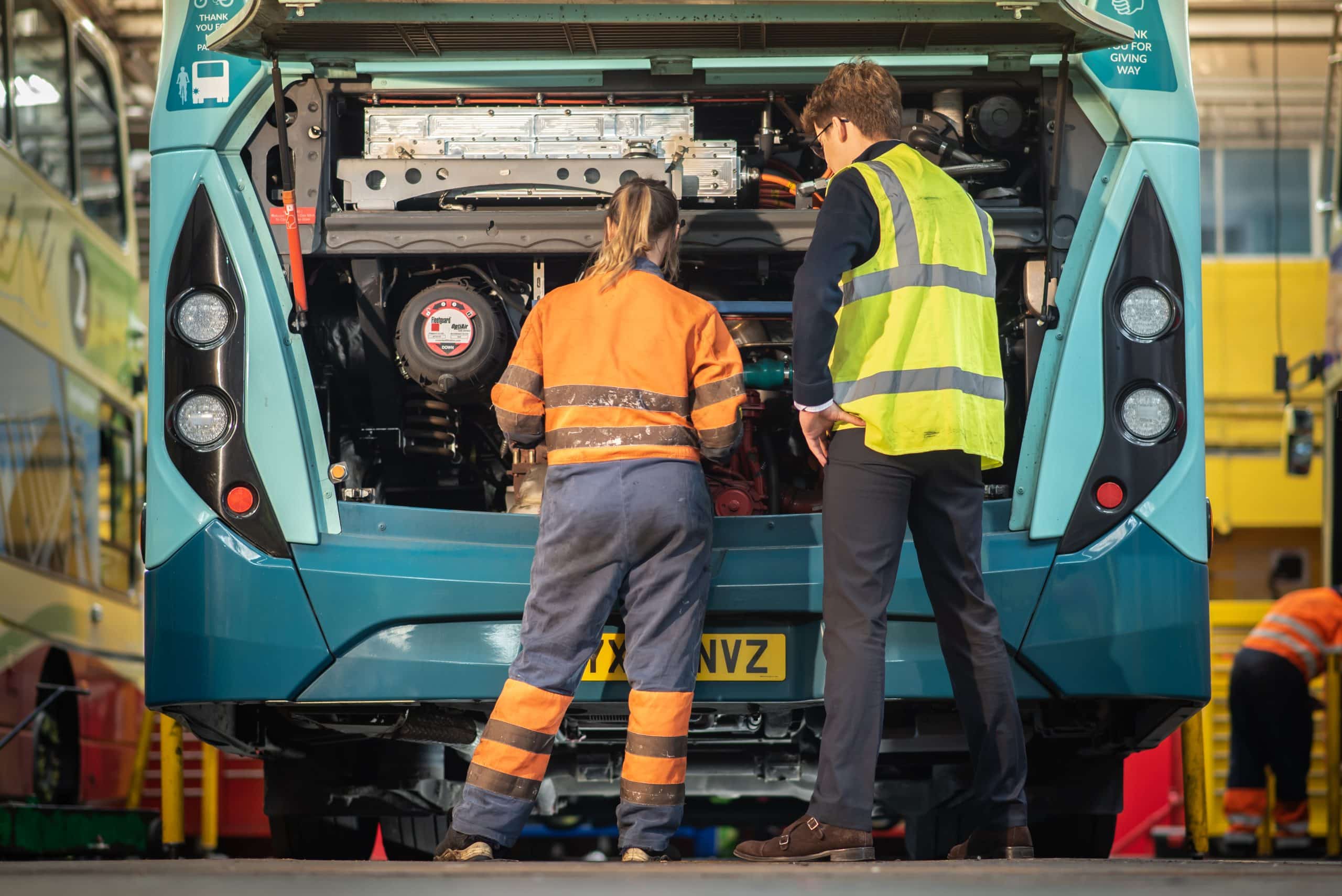 Engineers inspecting extended range bus 4 scaled