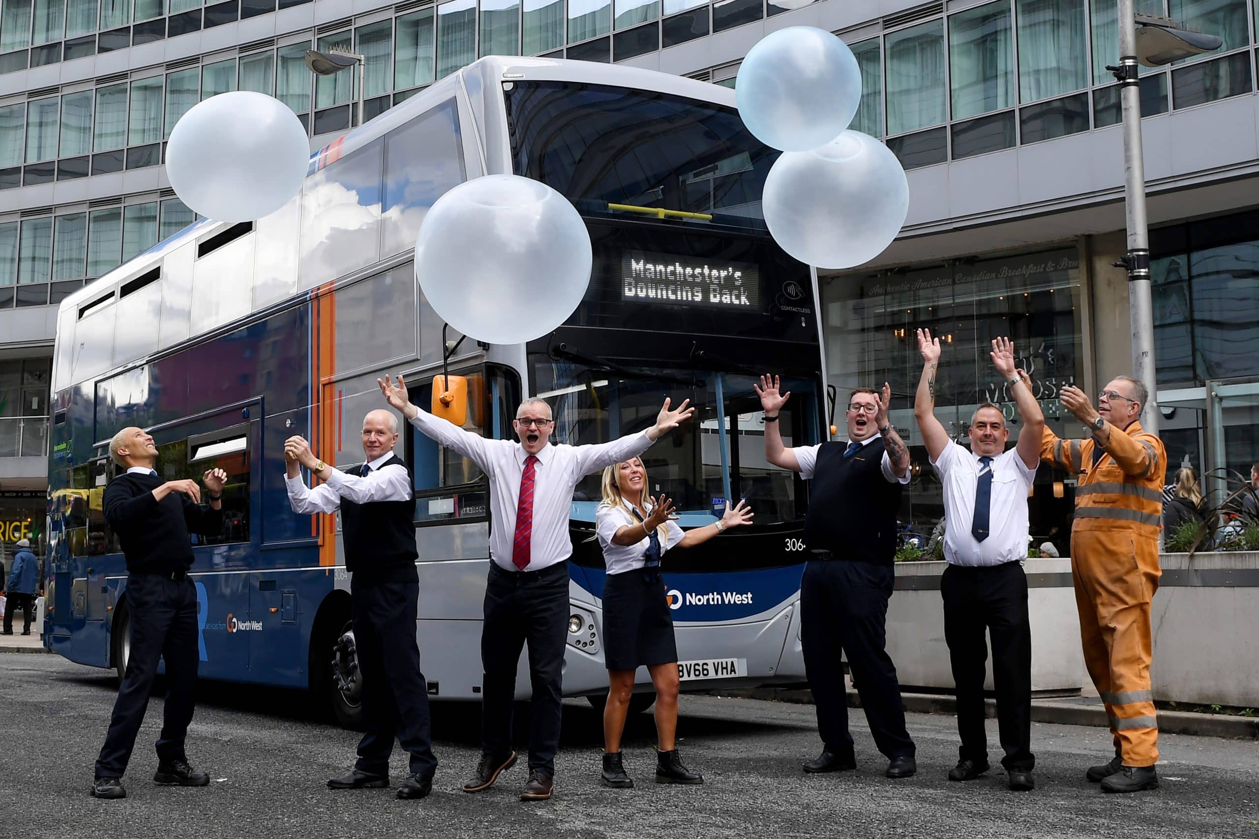 People celebrating Infront of a bus
